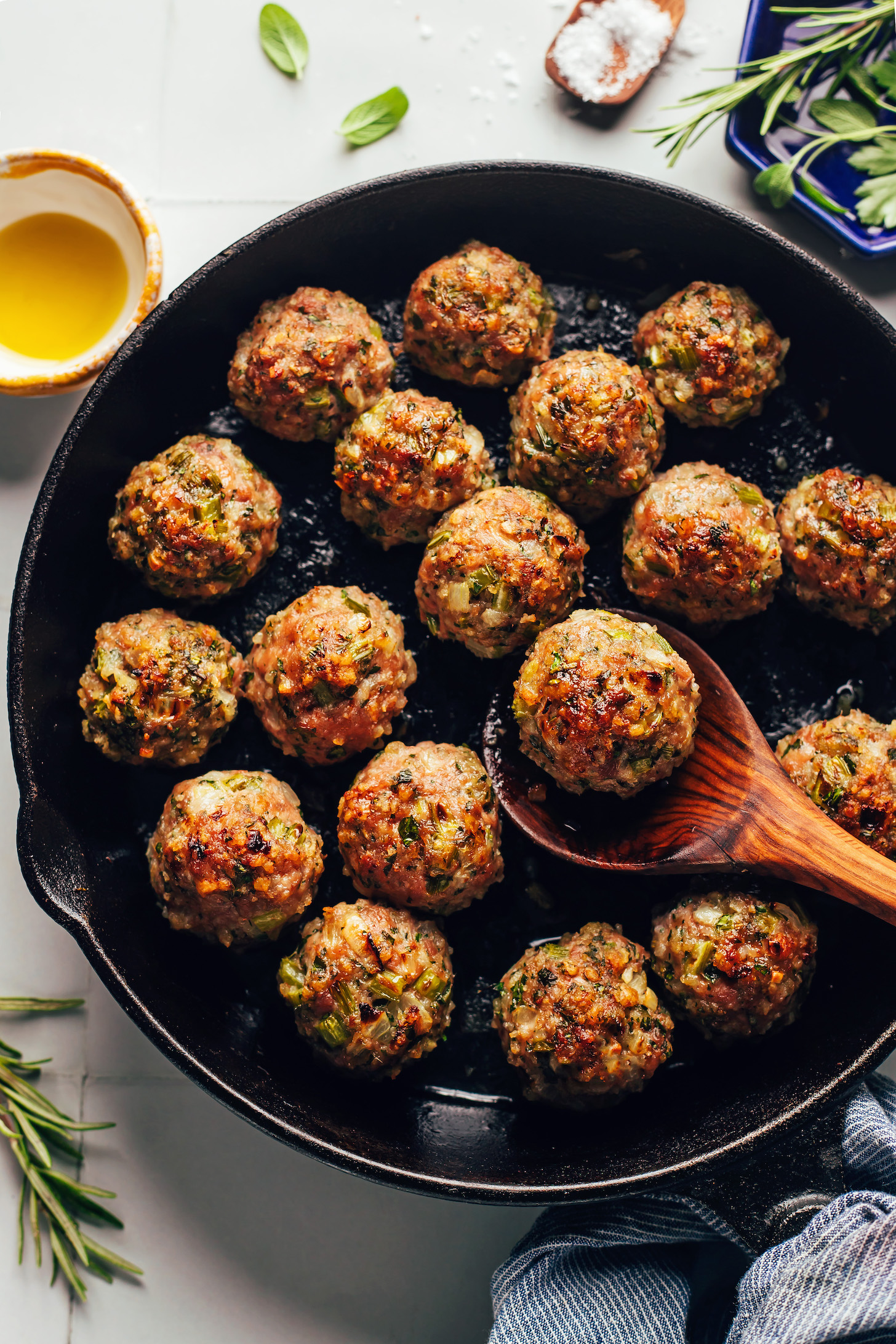 Cast iron skillet filled with a batch of perfectly browned Thanksgiving turkey meatballs