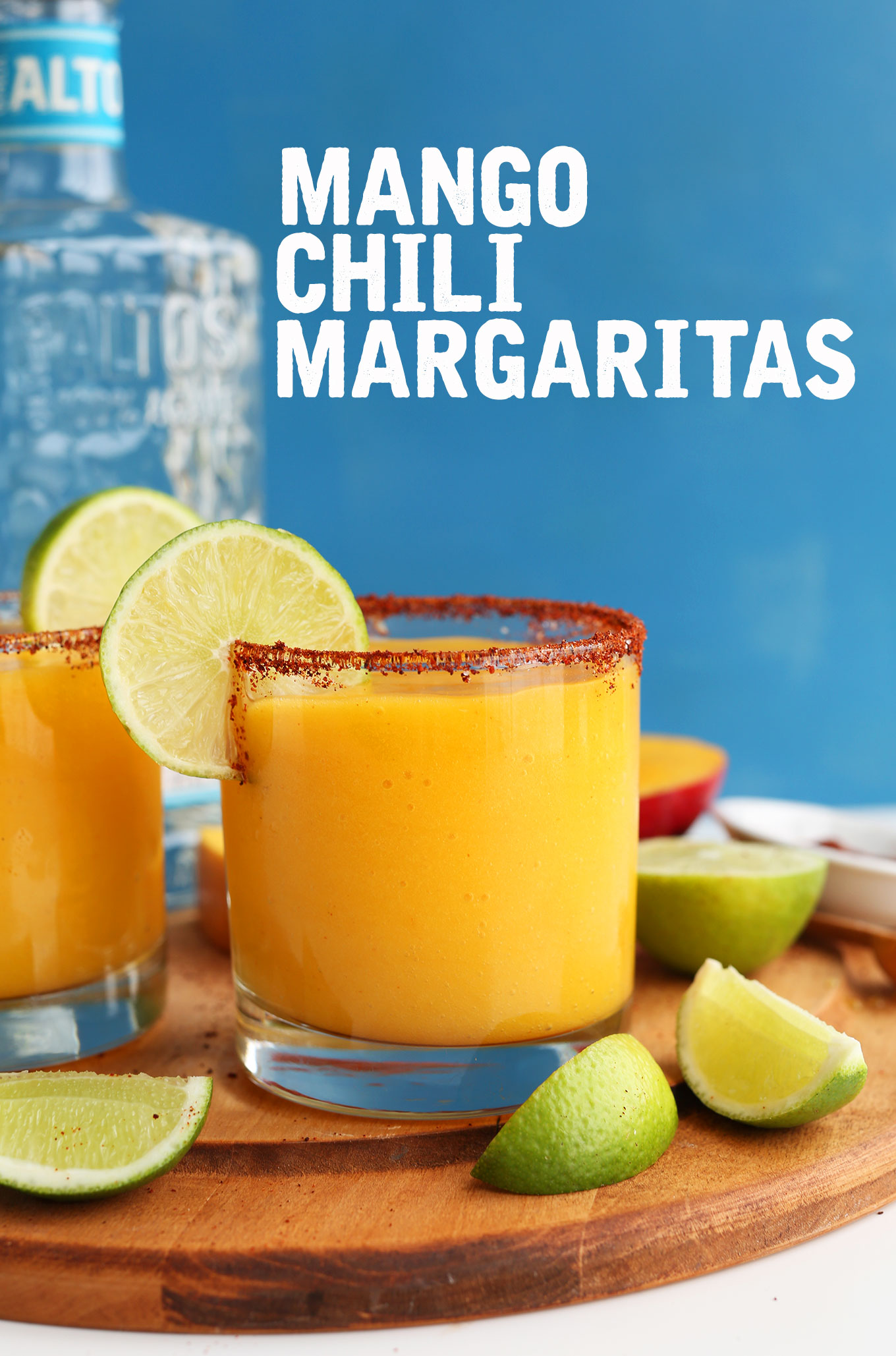 Close up shot of a glass of our vegan Mango Chili Lime Margarita with a chili lime rim